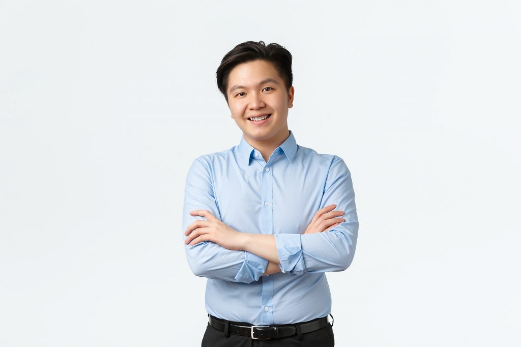Business, finance and people concept. Professional confident asian businessman with teeth braces