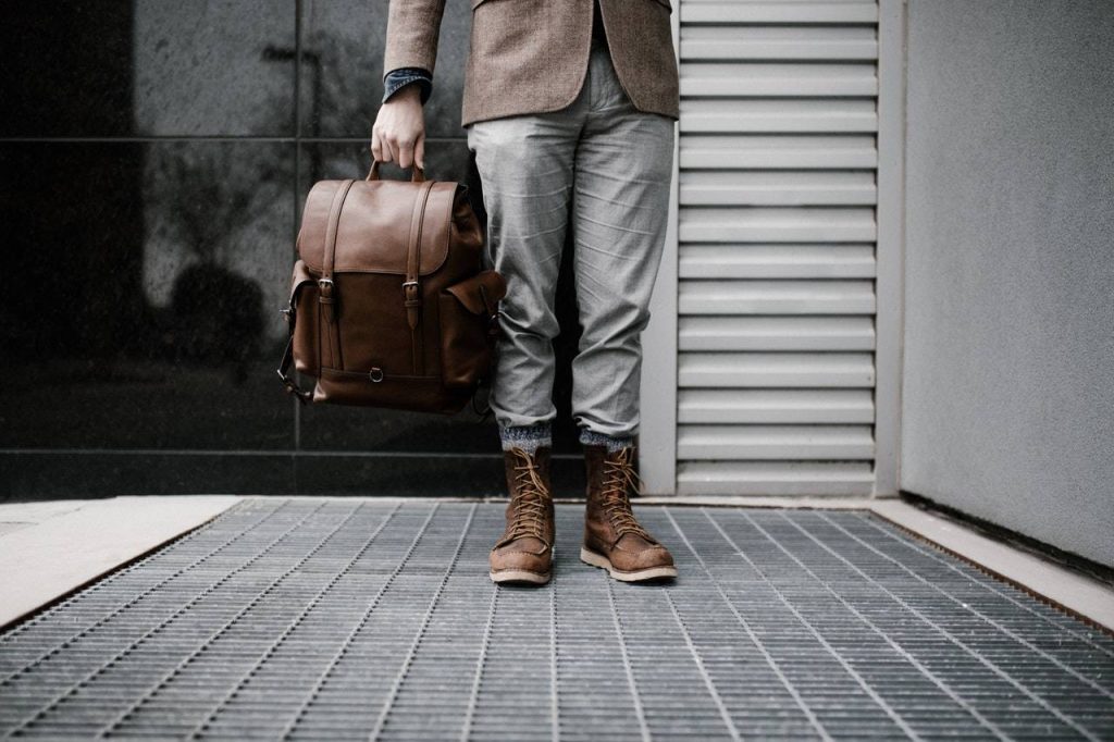 a man standing while holding a backpack - Darren Yaw Singapore