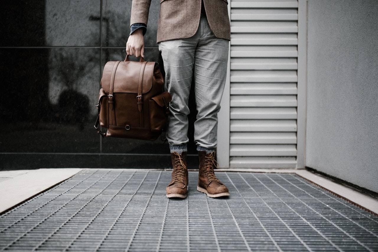 a man standing while holding a backpack - Darren Yaw Singapore